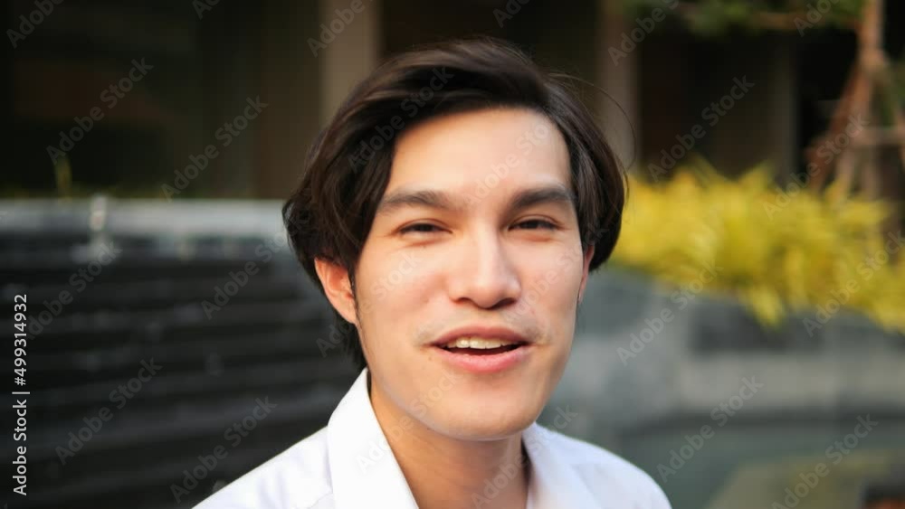 Lifestyle Portrait of Laughing Young Asian Man. High Quality 4K Slomotion Footage of Smiling Office worker or Student. Thailand. Lifestyle Portrait of Laughing Young Asian Man. High Quality 4K Slomotion Footage of Smiling Office worker or Student. Thailand.
