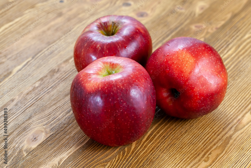 a red ripe apple cut into pieces on the table a red ripe apple cut into pieces on the table