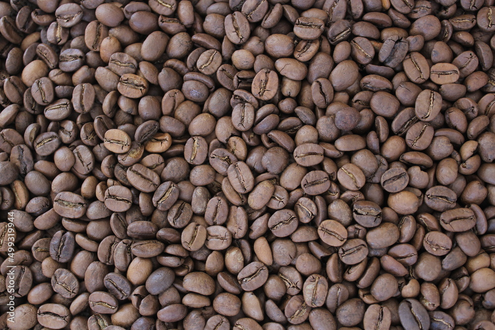 Fullframe shot of roasted coffee beans frome close up. Brown aromatic seeds on background. Fullframe shot of roasted coffee beans frome close up. Brown aromatic seeds on background.