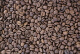 Fullframe shot of roasted coffee beans frome close up. Brown aromatic seeds on background.