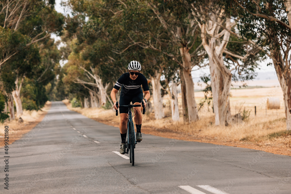 Professional cyclist practicing on a long empty road