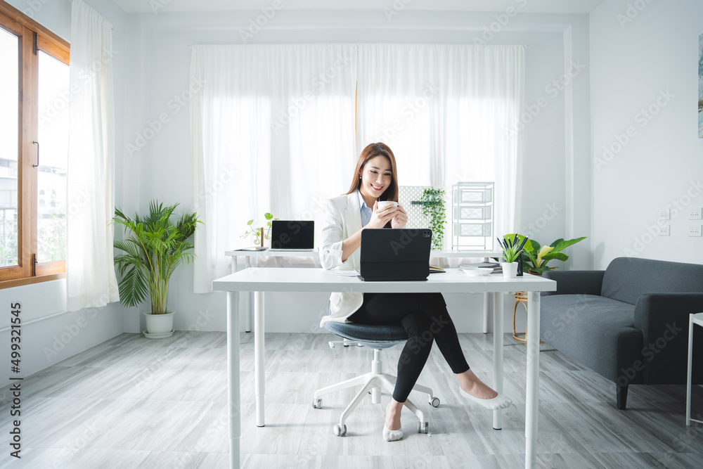 happy business woman working and holding a coffee cup at the office happy business woman working and holding a coffee cup at the office