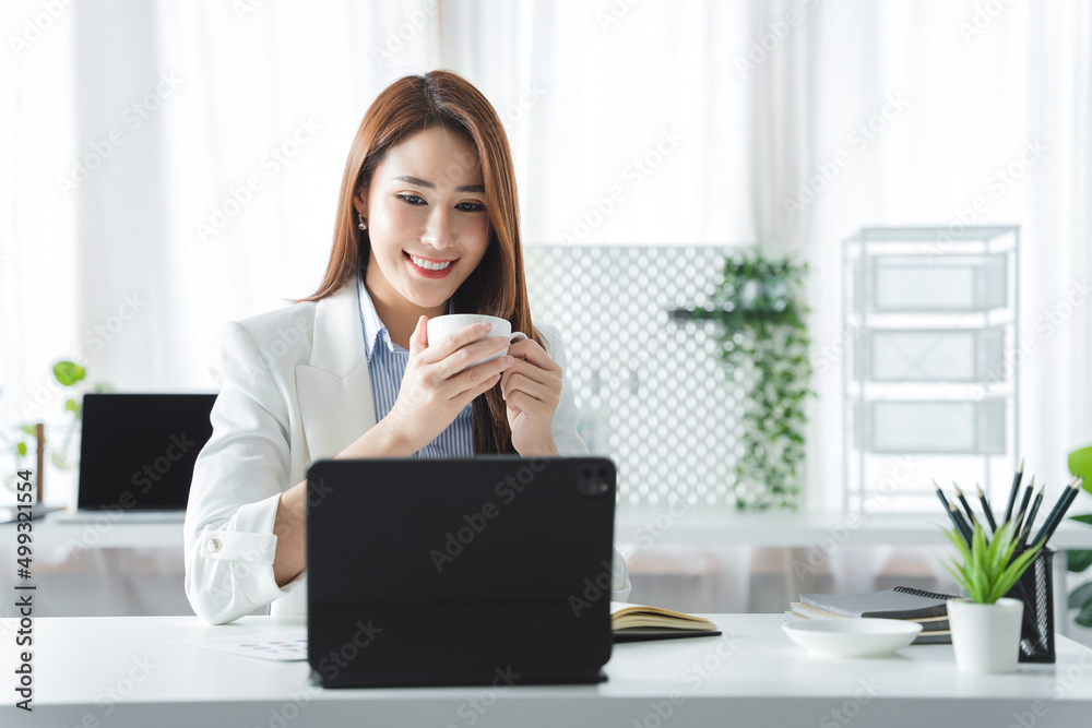 happy business woman working and holding a coffee cup at the office happy business woman working and holding a coffee cup at the office