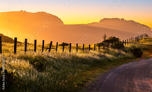 Big Sur sunset country road with rambling fence