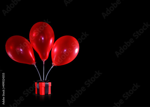 three red balloons above the gift box
