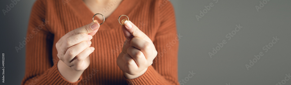female fingers holding wedding rings female fingers holding wedding rings