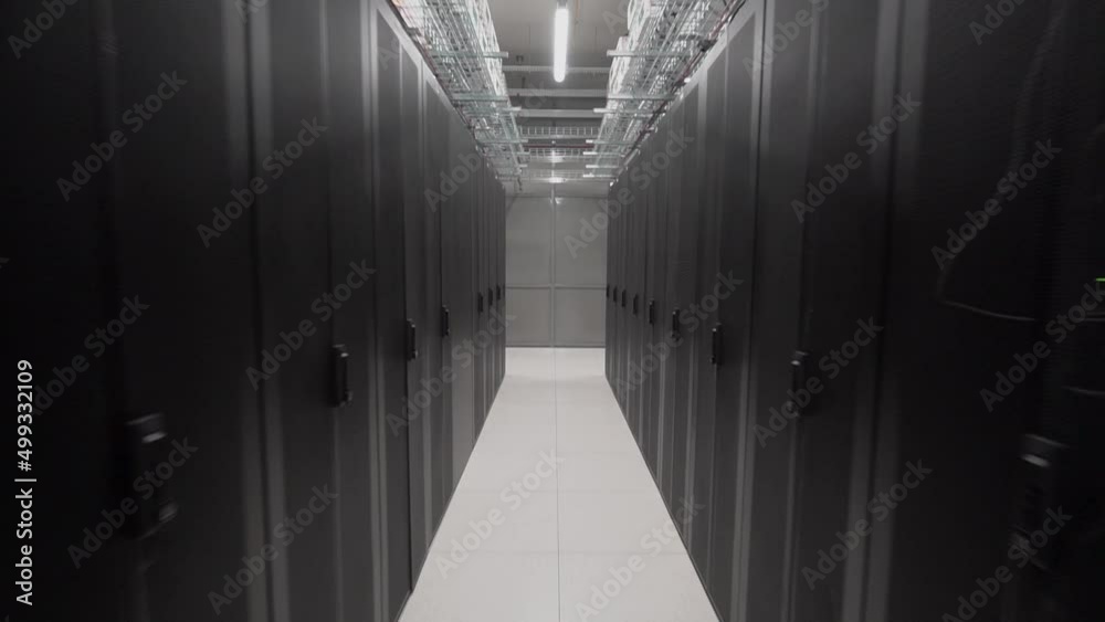 Cloud data server panels in a server room of a data center. Network and data servers behind glass panels in the server room of a data center or ISP. dark concept, the camera moves forward Cloud data server panels in a server room of a data center. Network and data servers behind glass panels in the server room of a data center or ISP. dark concept, the camera moves forward