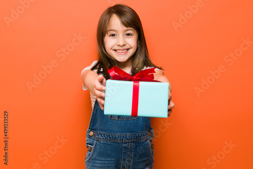 Cute girl handing over a present