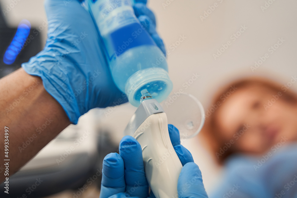 Ultrasonography hand holding ultrasound probe and coupling gel and