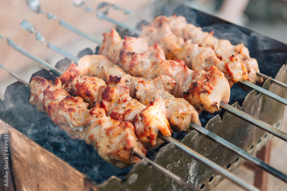 Many tasty appetizing shashlyk barbecute meat pieces on a grill.