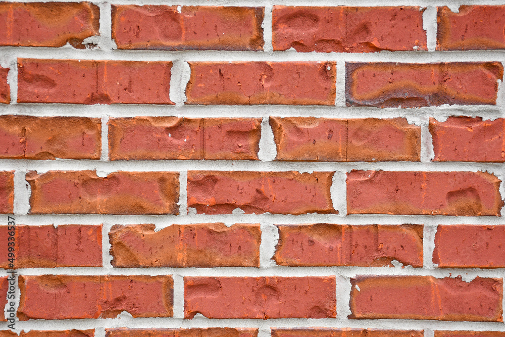 Fototapeta premium Close up of old imperfect historic brick wall on building in North Florida. 