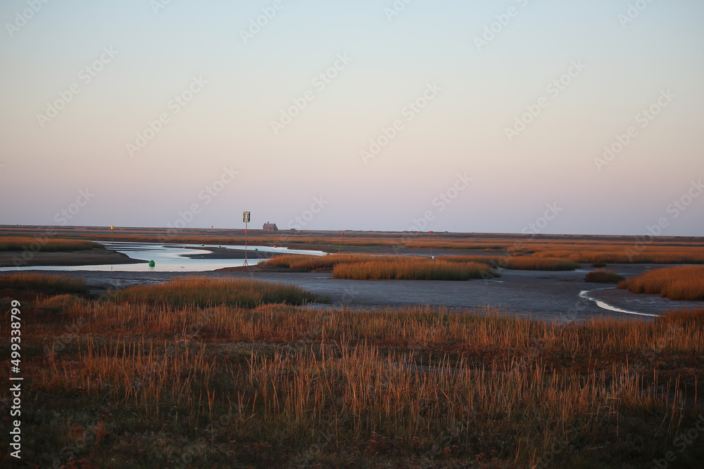 Sunset over the tidal marshes outside Blakeney in Norfolk, England during the autumn