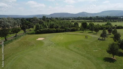 4K golf course drone footage, flyover over golf course with scenic backdrop on a summers day in England. 