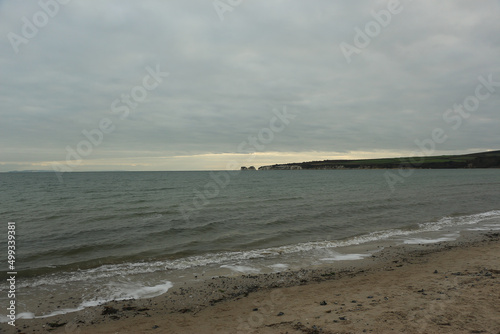 Exploring Studland Bay with views of Bournemouth and the Isle of Wight from the beach during the middle of winter