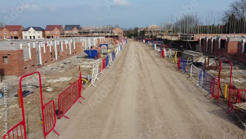ew UK housing development, showing houses under construction and new builds, in the UK. 4K Arial footage, high quality videography. UK housing project, all stages of construction and development.