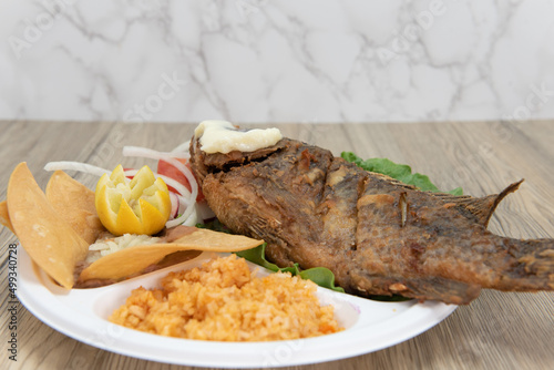 Mexican combination meal with fried mojarra fish served with rice and beans for a huge Latino meal photo