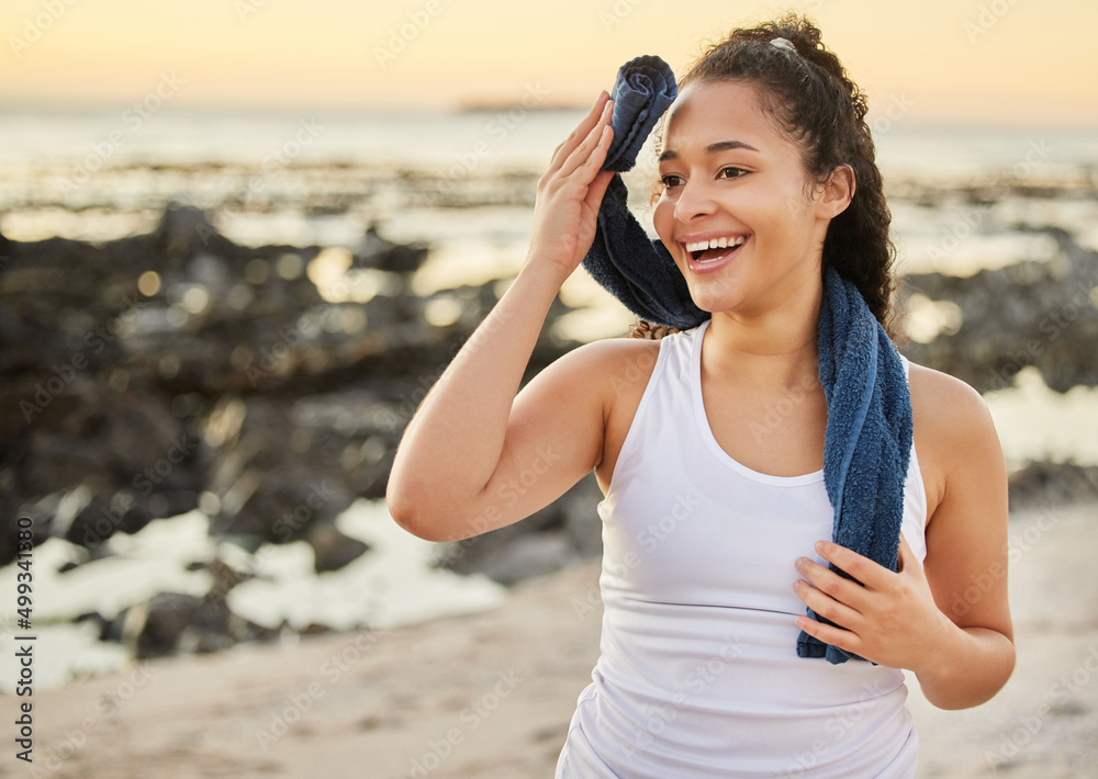 What a workout. Cropped shot of an attractive young woman wiping herself down after a workout on the beach. What a workout. Cropped shot of an attractive young woman wiping herself down after a workout on the beach.