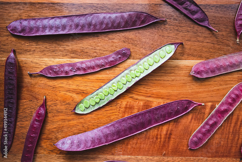 Guaje seed pods are scattered on a wood table in Oaxaca, Mexico. photo