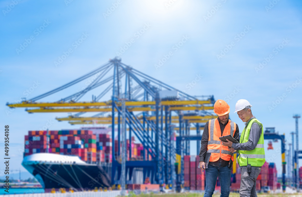 Engineer wearing uniform inspection and see detail on tablet with logistics container dock cargo yard with working crane bridge in shipyard with transport logistic import export background. - obrazy, fototapety, plakaty 