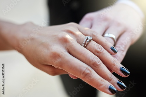 Showing off the symbol of their union. Cropped shot of a newlywed couple wearing their wedding rings.