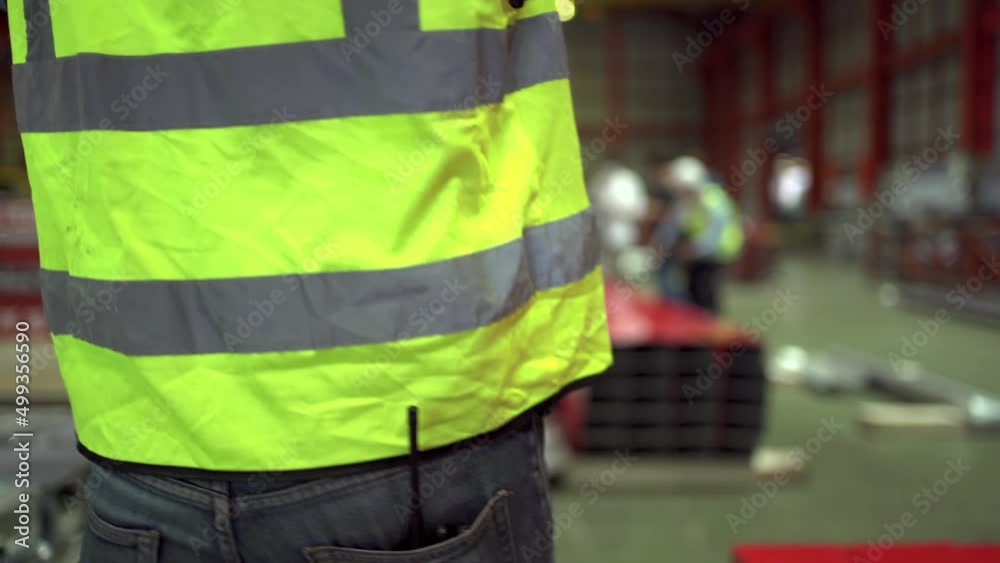 Unrecognizable industrial engineer picking up and wearing a hard helmet in the work place. Unrecognizable industrial engineer picking up and wearing a hard helmet in the work place.