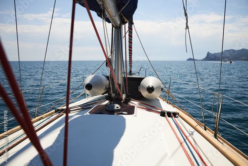 Sailing yacht moves along the coast of the Black Sea