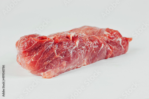 Red meat close up. Piece of pork isolated on a white background. Preparation for meat dishes.