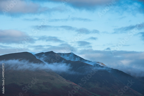 Stunning landscape image of Blencathra covered in low cloud fog and mist viewed from Walla Crag in Lake District photo