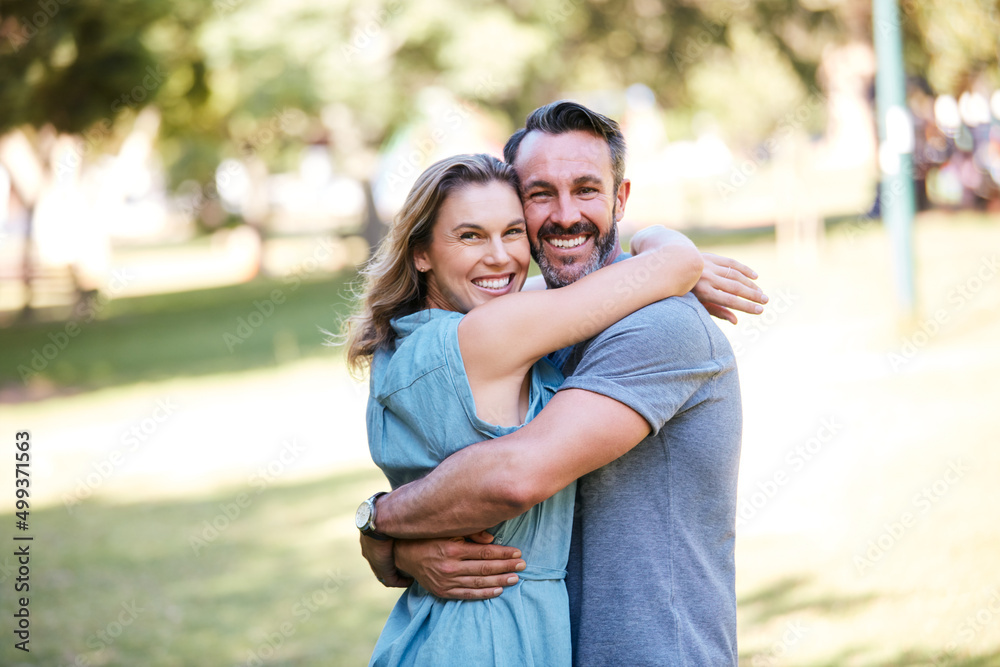 Hes handsome and hes all mine. Shot of a happy couple embracing in the park.