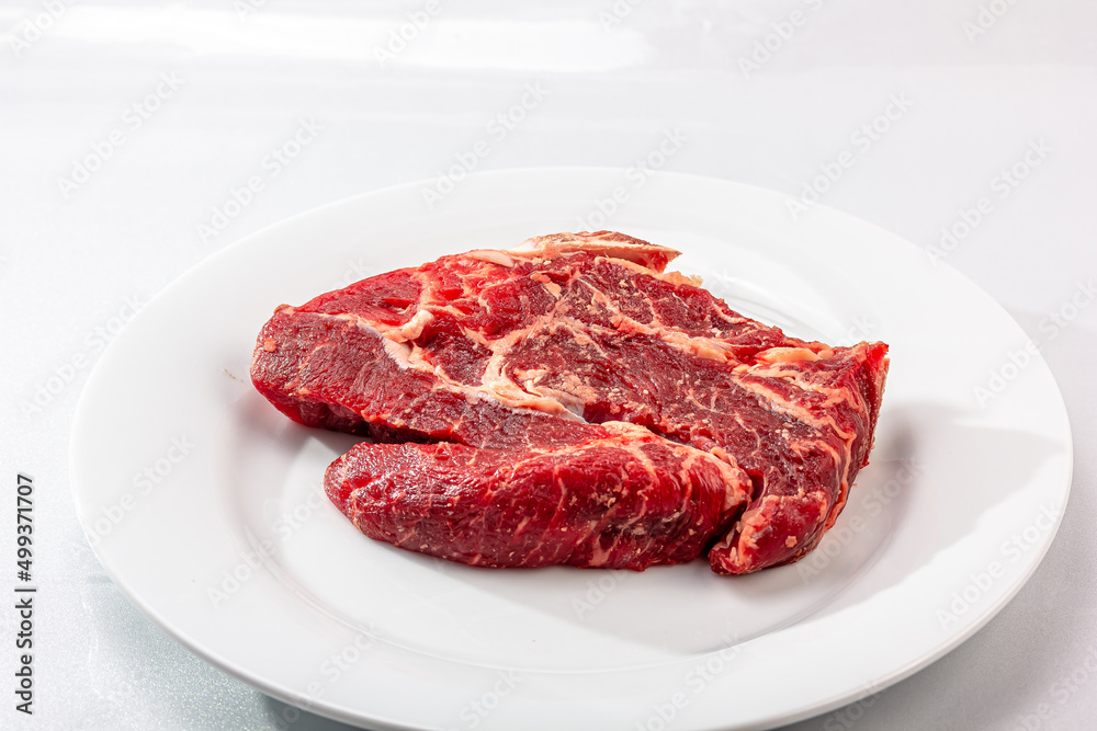 Raw marbled beef on a a white background