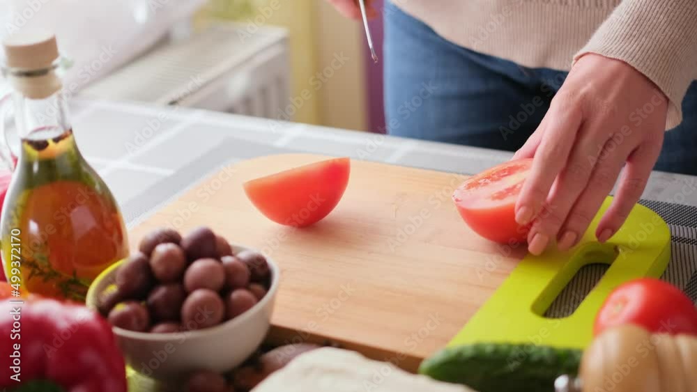 greek salad preparation series concept - woman cutting tomatoes greek salad preparation series concept - woman cutting tomatoes