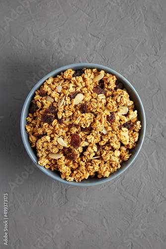 Homemade Granola with raisins and almonds  in a Bowl on a gray background, top view. Flat lay, overhead, from above.