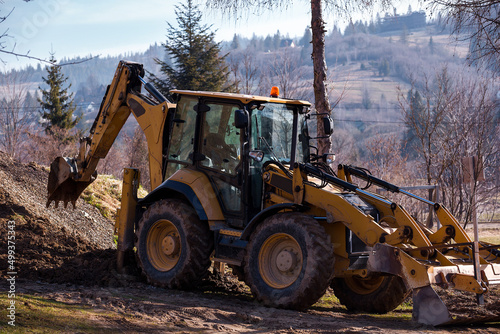 Wheel excavator loader is digging the soil at the construction site.