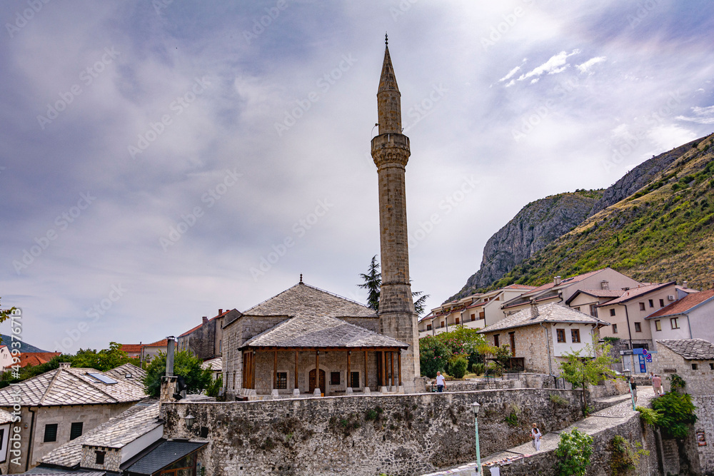 Beautiful view of an old ancient stone build mosque into the mountains at Mostar