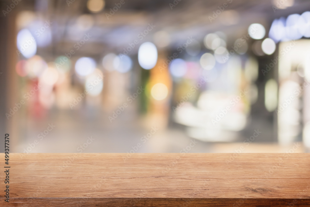 Empty wood table top and blurred shop and store interior background - can used for display or montage your products.