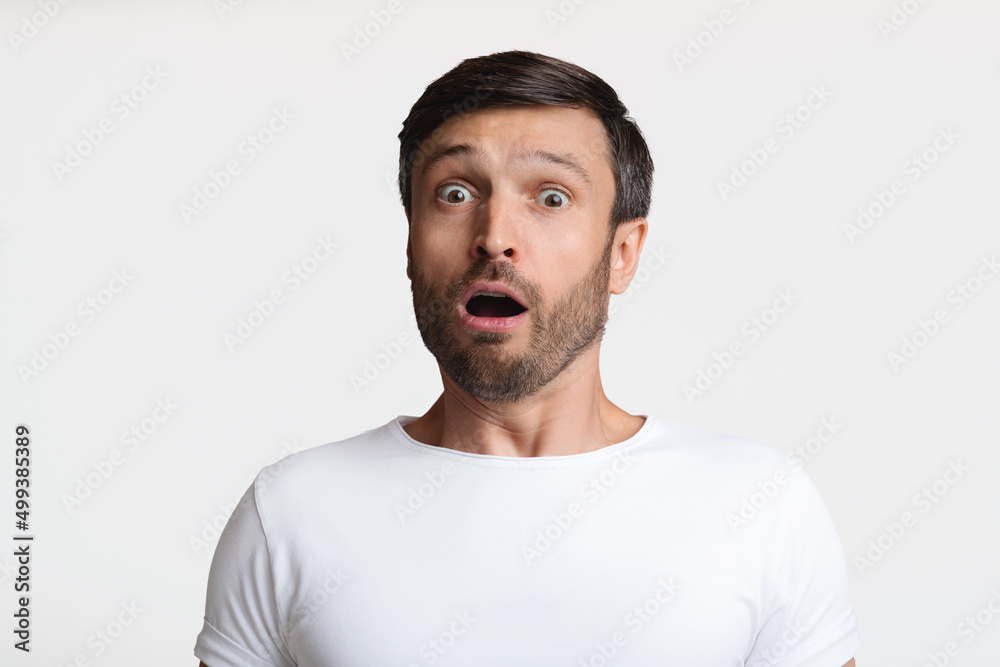 Shocked Man Looking At Camera Expressing Fear Over White Background Shocked Man Looking At Camera Expressing Fear Over White Background