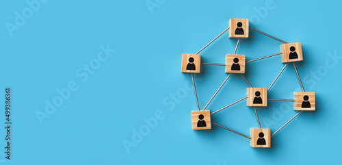 Fototapeta Naklejka Na Ścianę i Meble -  Wooden blocks with a people icon on a blue background with copy space. The concept of human resources and team management. 3D rendering. Horizontal banner, poster, website header.