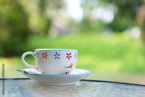 Vintage coffee cup with green nature background