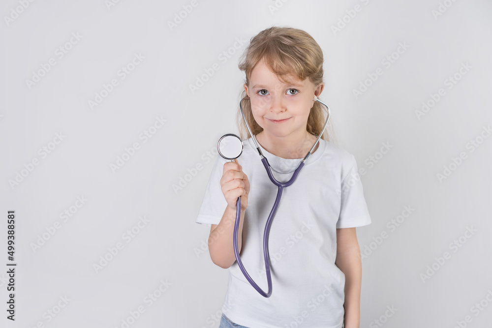a little girl doctor  with a stethoscope. white background. health check concept