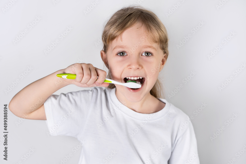 little girl brushing teeth. the concept of dental health