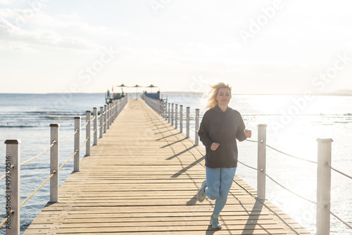 woman runs on a pontoon bridge in the Red Sea