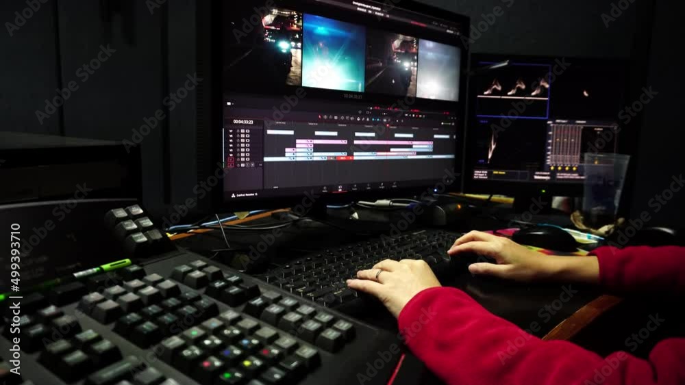 Colorist in a dark studio using modern color grading tools and equipment.Colour Grading.Soft focus.Selective focus.  