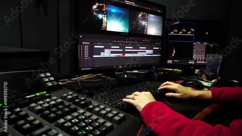 Colorist in a dark studio using modern color grading tools and equipment.Colour Grading.Soft focus.Selective focus.  