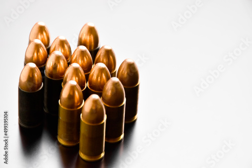 9mm pistol bullets on gray background, soft and selective focus.