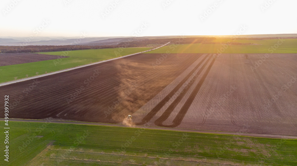 Spring Cultivation of Agricultural Land at sunset