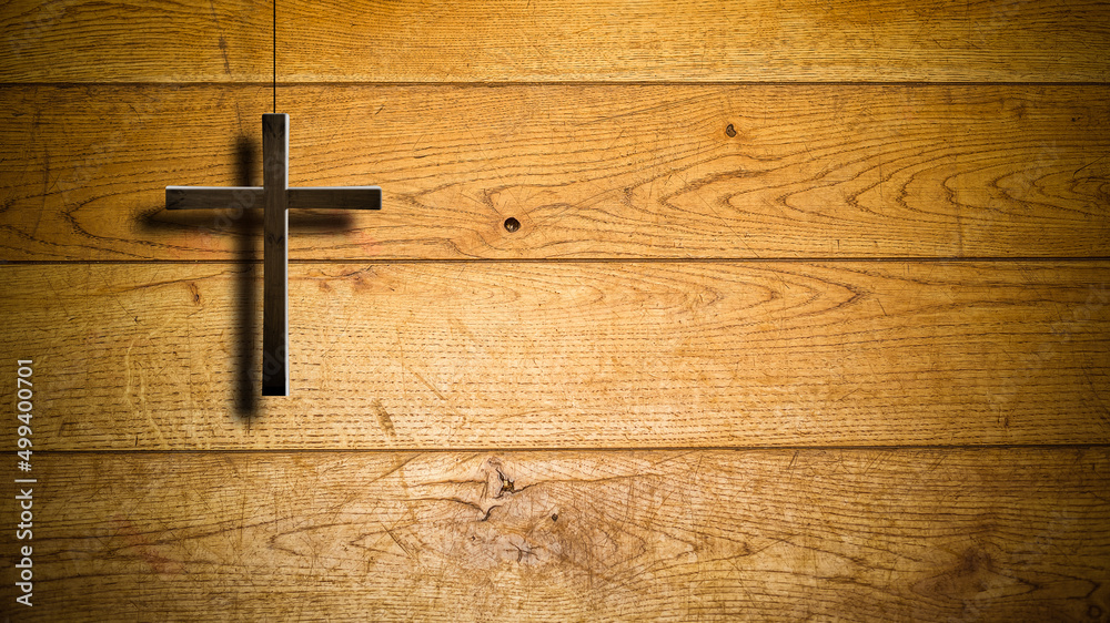 Christian wooden cross on a background of walls