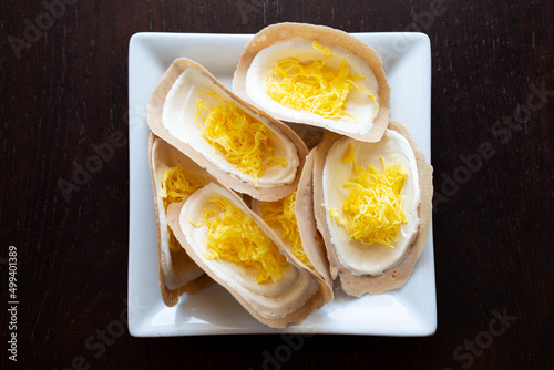 Thai crispy pancake (Khanom bueang) on white plate.