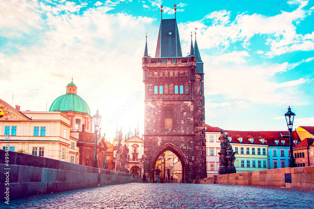 cute fascinating mystical landscape with arch-tower on Charles Bridge in an old city in Prague, Czech Republic at dawn. amazing places. popular tourist atraction