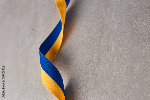 Ukrainian national flag colors on beton background. fabric of Yellow and blue colors. Ukraine nation independence celebration symbol photo