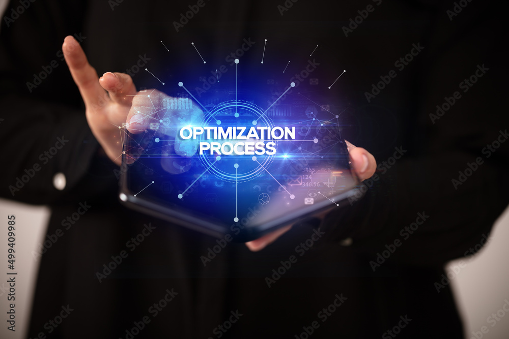 Businessman holding a foldable smartphone, new business concept Businessman holding a foldable smartphone, new business concept